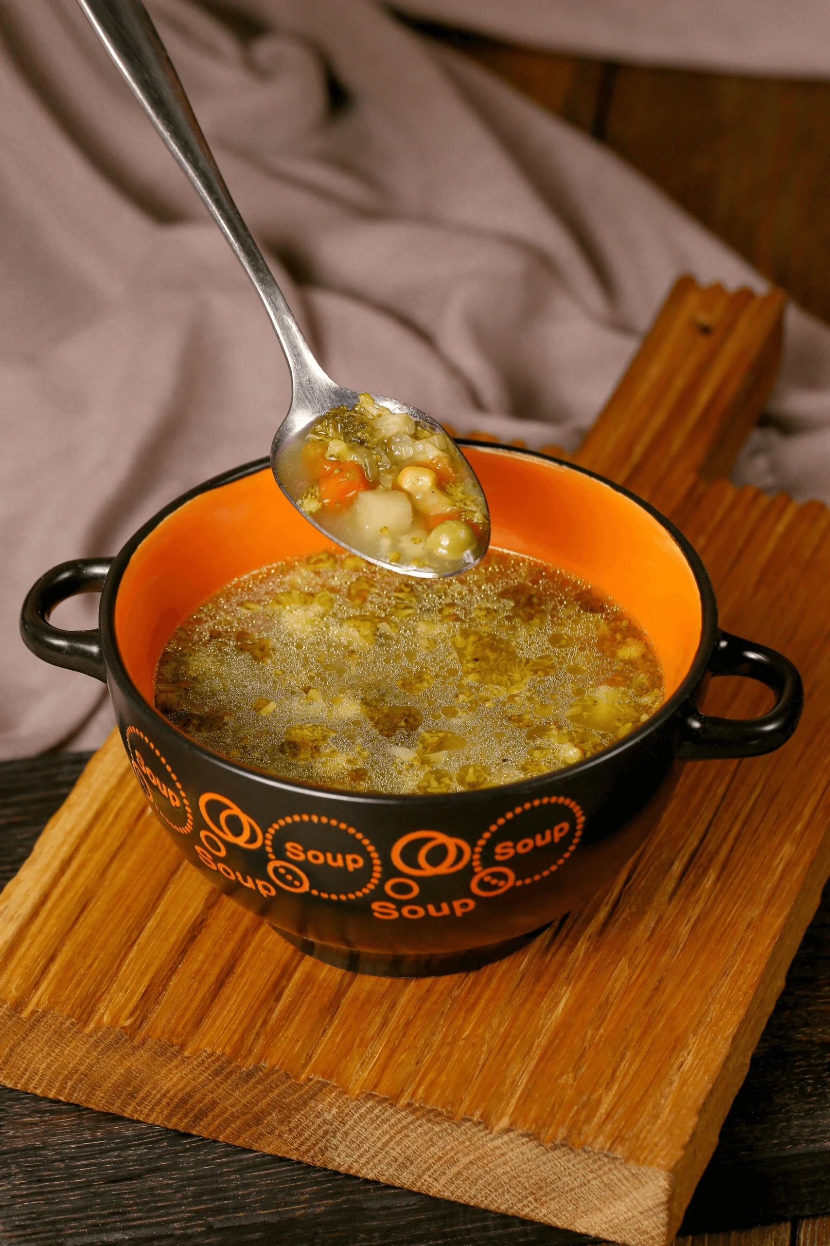 Close-up of a hearty soup bone, surrounded by fresh herbs and vegetables, ready for cooking in a rich and flavorful broth.