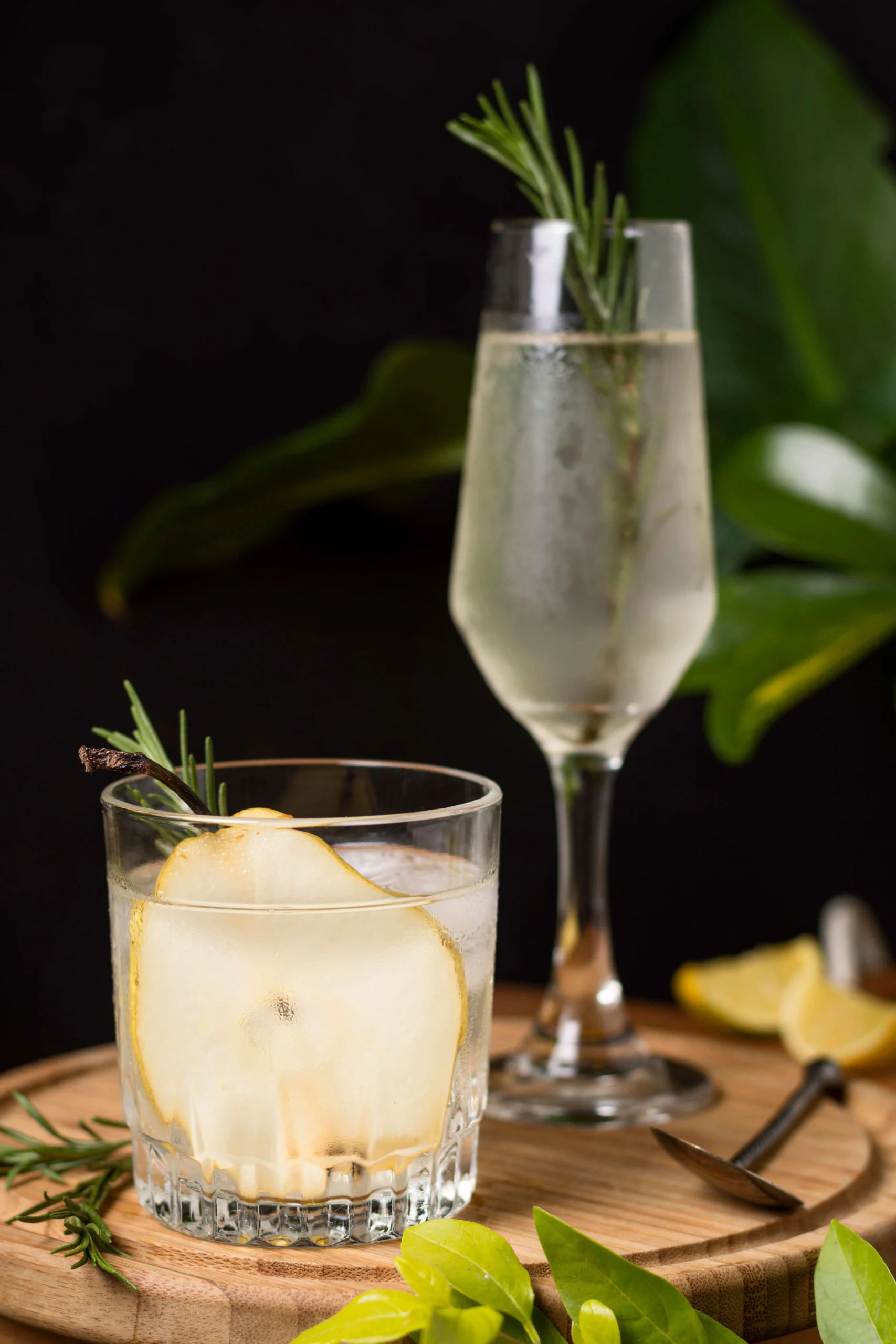 A glass of Hugo Spritz cocktail with elderflower, Prosecco, mint, and lime on a summer table.