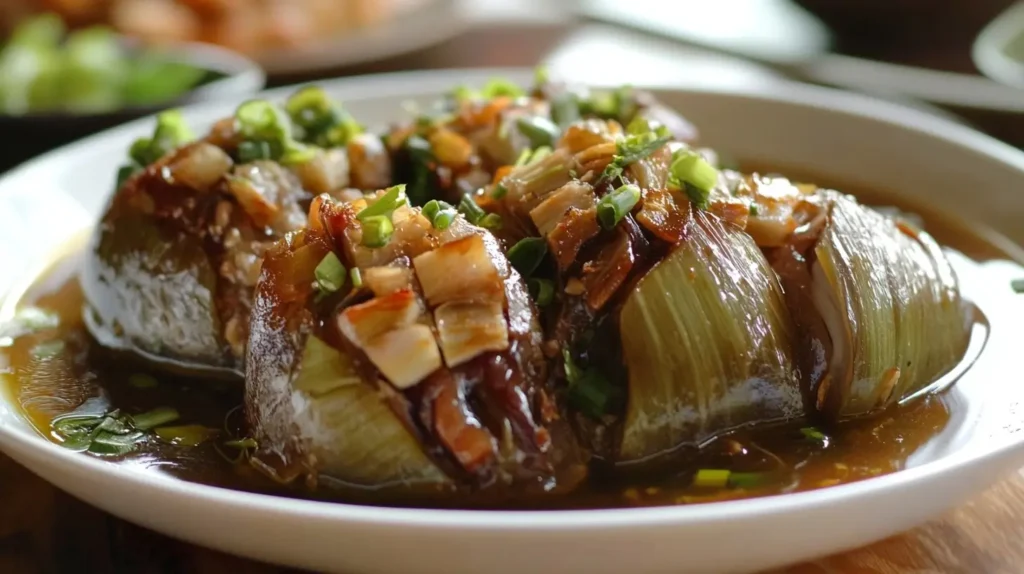 A bowl of traditional Filipino Papaitan stew made with beef or goat innards, garnished with green onions and served with steamed rice.